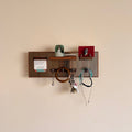 ROZ wall organiser made from teak and stainless steel, mounted on wall