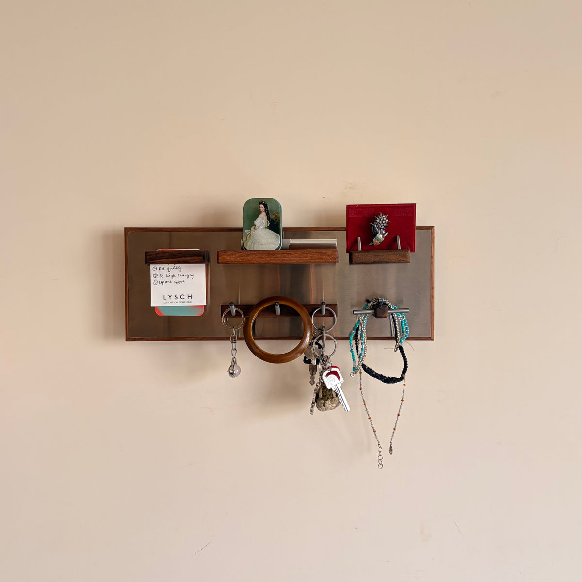 ROZ wall organiser made from teak and stainless steel, mounted on wall